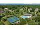 An aerial view captures community amenities, including pool and tennis courts, nestled amongst trees at 765 Portpatrick Pl, Fort Mill, SC 29708