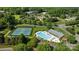 Aerial view showcasing community pool, tennis courts and surrounding lush greenery at 765 Portpatrick Pl, Fort Mill, SC 29708
