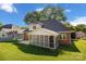A screened porch sits off the back of this brick home, leading to a patio and large grassy backyard at 765 Portpatrick Pl, Fort Mill, SC 29708