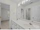 Bright bathroom featuring a double sink vanity with large mirror and white cabinets at 765 Portpatrick Pl, Fort Mill, SC 29708