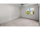 A bright bedroom with neutral carpet and a window providing natural light at 765 Portpatrick Pl, Fort Mill, SC 29708