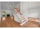 Bright home featuring a living room with fireplace, staircase, and dining room at 765 Portpatrick Pl, Fort Mill, SC 29708