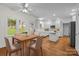 Eat-in kitchen with hardwood floors, white cabinetry and island at 765 Portpatrick Pl, Fort Mill, SC 29708