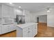 Open kitchen featuring white cabinets, island, and stainless steel appliances at 765 Portpatrick Pl, Fort Mill, SC 29708