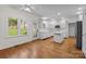 Eat-in kitchen with hardwood floors, white cabinetry and island at 765 Portpatrick Pl, Fort Mill, SC 29708