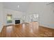 Spacious living room with fireplace, hardwood floors, and bright light at 765 Portpatrick Pl, Fort Mill, SC 29708
