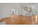 Bright living room with vaulted ceiling, hardwood floors, and staircase leading to the upper level at 765 Portpatrick Pl, Fort Mill, SC 29708