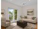 Cozy staged living room with neutral decor, large window, and comfortable seating at 765 Portpatrick Pl, Fort Mill, SC 29708