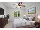 Tastefully staged main bedroom with ample natural light, a ceiling fan, and comfortable furniture at 765 Portpatrick Pl, Fort Mill, SC 29708