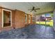 Spacious screened porch featuring tile flooring, ceiling fan, and an open view of the backyard at 765 Portpatrick Pl, Fort Mill, SC 29708