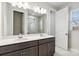 Elegant bathroom with dual sinks, a large mirror, and a glass-enclosed shower, creating a luxurious space at 9142 Widden Way, Charlotte, NC 28269