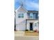 Charming two-story home with a light gray exterior, blue accent, and a one-car garage, offering curb appeal at 9142 Widden Way, Charlotte, NC 28269