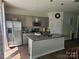 Modern kitchen with stainless steel appliances, granite countertops, and stylish pendant lighting at 9142 Widden Way, Charlotte, NC 28269