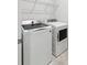 Well-equipped laundry room with a modern washer and dryer, plus wire shelving for optimal storage at 9142 Widden Way, Charlotte, NC 28269