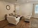 Well-lit living room with hardwood flooring, neutral colors, and comfortable seating arrangement at 9142 Widden Way, Charlotte, NC 28269