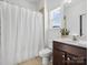 Bathroom featuring a shower with curtain and vanity with dark wood cabinets and window at 1001 Hampton Grove Rd, Waxhaw, NC 28173
