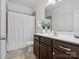 Bright bathroom featuring a shower with curtain and vanity with dark wood cabinets at 1001 Hampton Grove Rd, Waxhaw, NC 28173