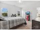 Bedroom with a bed, two windows with blinds and a wooden dresser and a TV at 1001 Hampton Grove Rd, Waxhaw, NC 28173