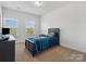 Cozy bedroom with neutral carpet, ample natural light from two windows, and closet at 1001 Hampton Grove Rd, Waxhaw, NC 28173
