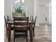 Elegant dining room featuring hardwood flooring, a stylish chandelier, and views of the landscaped yard at 1001 Hampton Grove Rd, Waxhaw, NC 28173