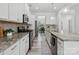 Modern kitchen featuring granite countertops, stainless steel appliances, white cabinets and tile backsplash at 1001 Hampton Grove Rd, Waxhaw, NC 28173