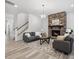 Comfortable living room showcasing a stone fireplace and staircase with neutral colors at 1001 Hampton Grove Rd, Waxhaw, NC 28173