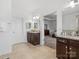 Elegant main bathroom featuring double vanities, tile floors, with open doorway into the main bedroom at 1001 Hampton Grove Rd, Waxhaw, NC 28173