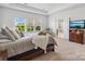 Comfortable main bedroom with a tray ceiling, large windows, and access to a bathroom at 1001 Hampton Grove Rd, Waxhaw, NC 28173