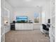 Cozy home office with built-in cabinets, a desk area, and multiple windows for natural light at 1001 Hampton Grove Rd, Waxhaw, NC 28173