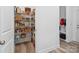 Well-stocked walk-in pantry with wire shelves and a variety of food items, adding convenience and storage at 1001 Hampton Grove Rd, Waxhaw, NC 28173