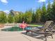 Backyard pool with lounge chairs and trees for privacy at 1001 Hampton Grove Rd, Waxhaw, NC 28173