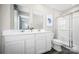 Bright bathroom featuring double sink vanity and a glass enclosed walk-in shower at 10116 Florentine Way, Charlotte, NC 28214