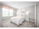Cozy bedroom filled with natural light featuring a queen bed with a pink comforter at 10116 Florentine Way, Charlotte, NC 28214