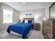 Comfortable bedroom features a bed with a blue comforter, bedside tables, and a dresser at 10116 Florentine Way, Charlotte, NC 28214