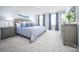 Serene bedroom with a comfortable king-sized bed, stylish nightstands, and soft, natural lighting at 10116 Florentine Way, Charlotte, NC 28214