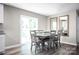 Bright dining room featuring a rustic table with six chairs and natural light from sliding glass doors at 10116 Florentine Way, Charlotte, NC 28214