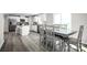 Open-concept design seamlessly connects the kitchen island with bar stools and the dining area at 10116 Florentine Way, Charlotte, NC 28214