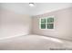 Bright, carpeted bedroom with a large window providing natural light and a view of the outdoors at 1059 Sage Pine Cir, Clover, SC 29710