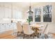Elegant dining room with white cabinets, large windows, stylish chandelier, and seating for six at 1059 Sage Pine Cir, Clover, SC 29710