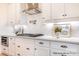 Bright kitchen features white cabinets, stainless appliances, white subway tile, and under cabinet lighting at 1059 Sage Pine Cir, Clover, SC 29710
