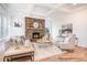 Inviting living room features a stone fireplace, large windows, light wood floors, and neutral furnishings at 1059 Sage Pine Cir, Clover, SC 29710