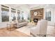 Cozy living room features a stone fireplace, large windows, light wood floors, and neutral furnishings at 1059 Sage Pine Cir, Clover, SC 29710
