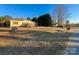 Inviting single-story home with a well-maintained lawn, quaint front porch, and red window shutters at 110 Dorothy Ln, Mooresville, NC 28117