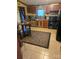 Functional kitchen with wooden cabinets, tile floor, and modern black appliances under warm lighting at 110 Dorothy Ln, Mooresville, NC 28117