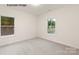 This room features two windows and neutral walls at 11009 Tyler Brook Ln # Oak0043, Mint Hill, NC 28227