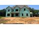 New construction showing wrapped walls, window framing, and the early stages of this custom home at 11009 Tyler Brook Ln # Oak0043, Mint Hill, NC 28227