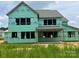 New construction showing wrapped walls, window framing, and the early stages of this custom home at 11009 Tyler Brook Ln # Oak0043, Mint Hill, NC 28227