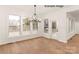 A bright dining area features large windows, hardwood flooring, and a modern light fixture at 11009 Tyler Brook Ln # Oak0043, Mint Hill, NC 28227