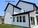 A bright modern home shows a clean design with black gutters, white siding, and lots of large windows at 11009 Tyler Brook Ln # Oak0043, Mint Hill, NC 28227
