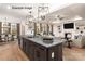 Open concept kitchen and living space with large island, fireplace, and hardwood floors at 11009 Tyler Brook Ln # Oak0043, Mint Hill, NC 28227